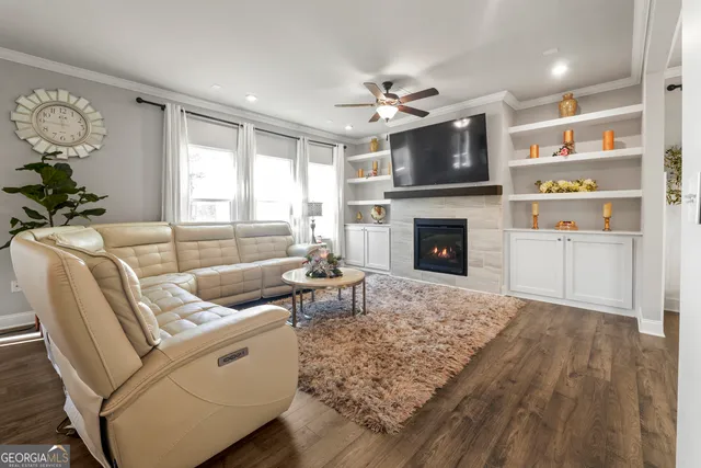 a living room with furniture fireplace and flat screen tv