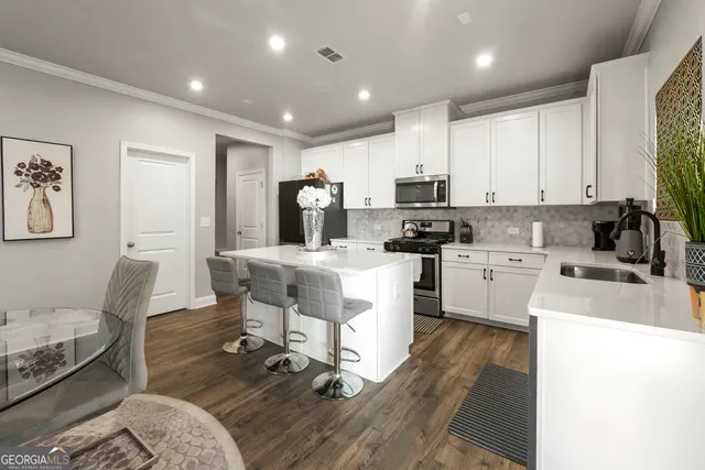a kitchen with cabinets a sink a counter and appliances