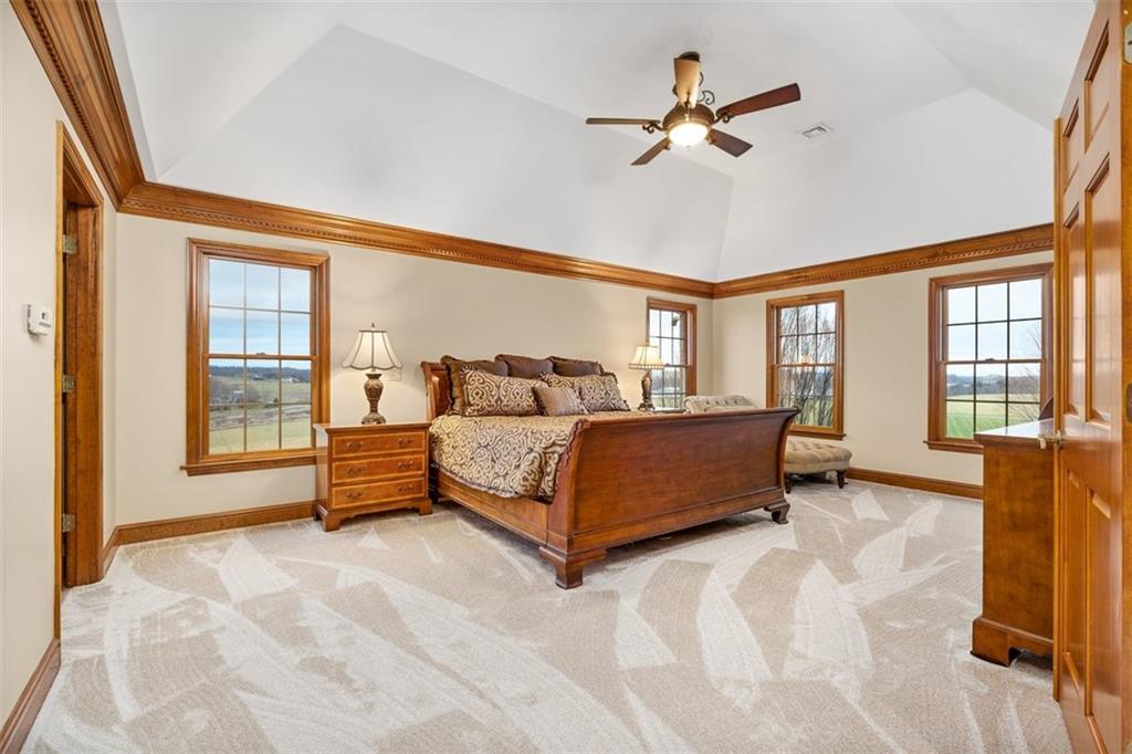 225 Church Road Fombell, PA 16123 - Photo 24 of 45 a bedroom with a bed a ceiling fan and a large window with the outer view