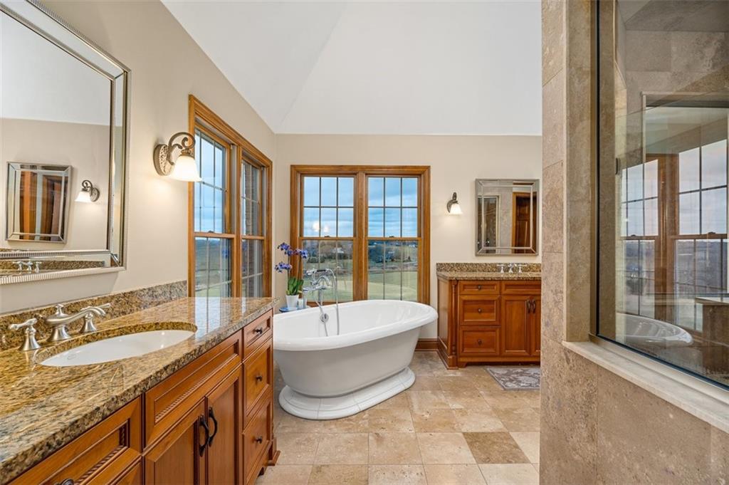 225 Church Road Fombell, PA 16123 - Photo 26 of 45 a spacious bathroom with a granite countertop tub sink and mirror