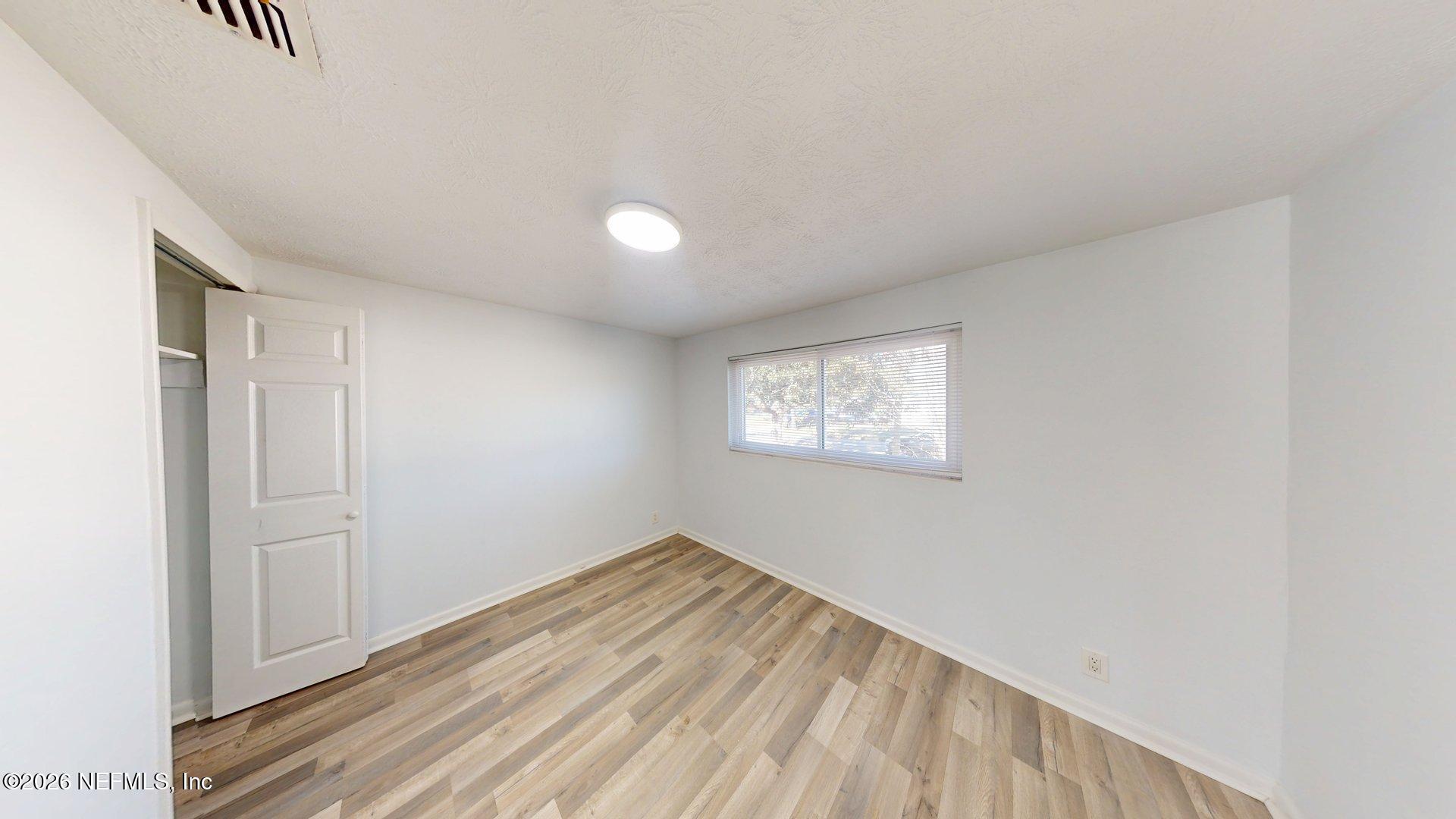 5246 Devron Drive Jacksonville, FL 32209 - Photo 11 of 18 a view of empty room with wooden floor