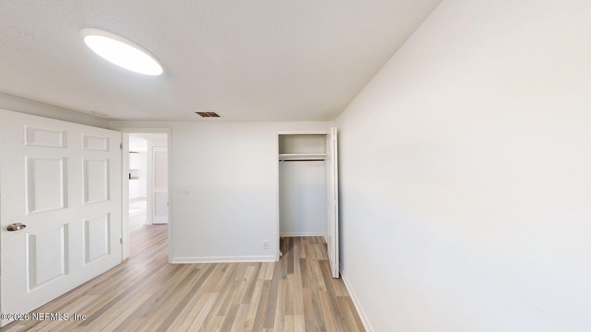 5246 Devron Drive Jacksonville, FL 32209 - Photo 13 of 18 a view of a hallway with wooden floor
