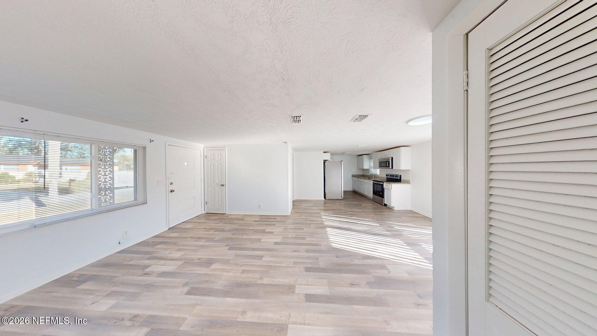5246 Devron Drive Jacksonville, FL 32209 - Photo 14 of 18 a view of a hallway with a livingroom and a window