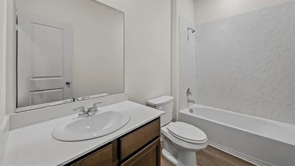a bathroom with a sink toilet and a mirror