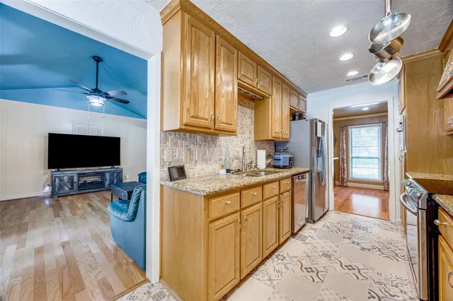 a kitchen with a sink stove and cabinets
