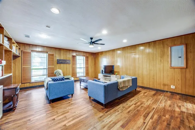 a living room with couch cabinet and a flat screen tv