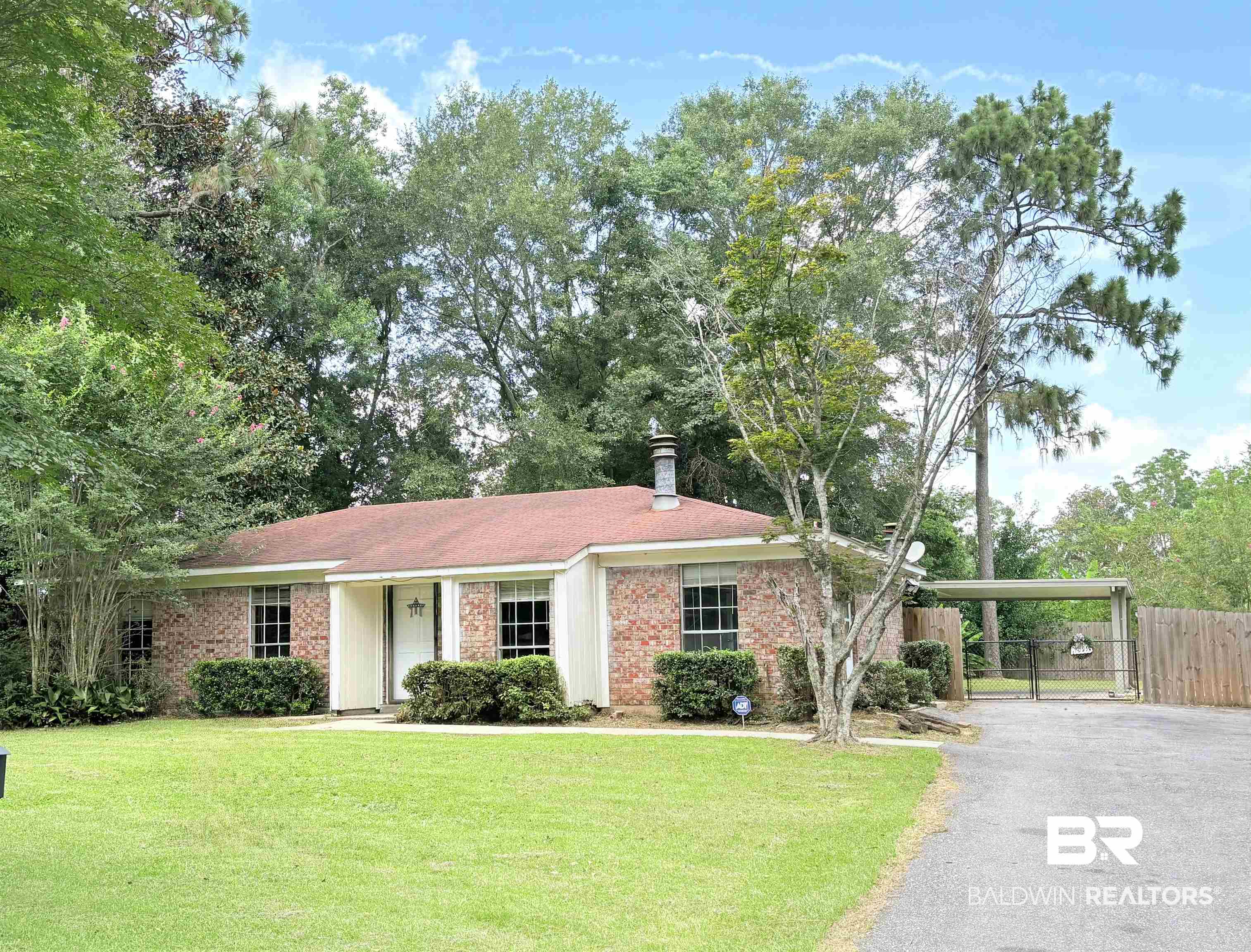 Single story home featuring brick siding and asphalt driveway