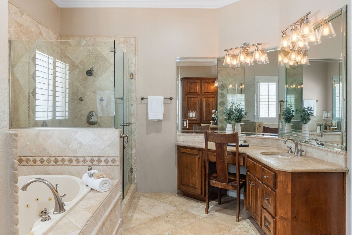 218 Courtnee's Way Georgetown, TX 78626 - Photo 19 of 36 The primary bathroom offers abundant counter space, providing plenty of room for two sinks, daily essentials, and elegant décor. The generous layout enhances both functionality and comfort, making it easy to get ready for the day or unwind in style ~