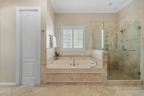 a bathroom with a tub shower and sink