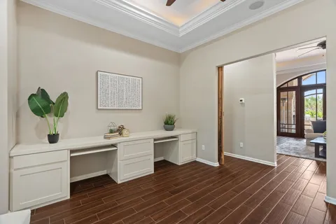 a view of a room with wooden floor and cabinet