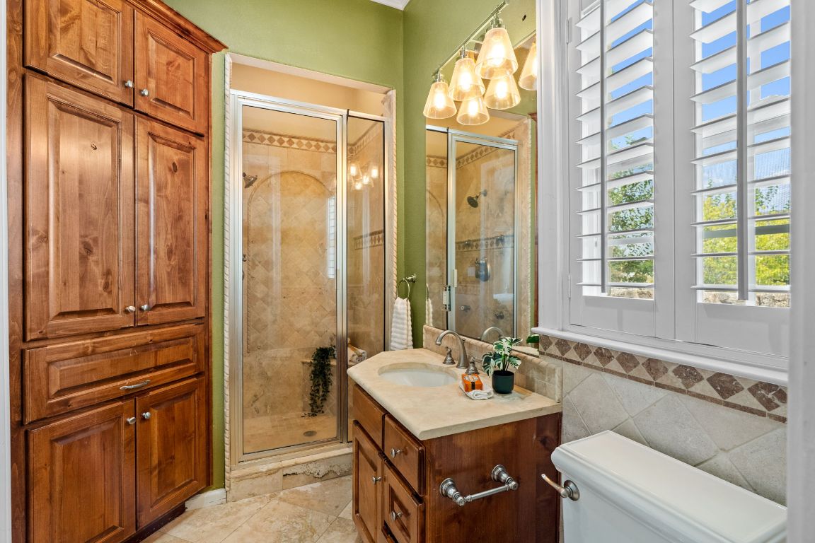 218 Courtnee's Way Georgetown, TX 78626 - Photo 25 of 36 The second ensuite bath is thoughtfully designed for comfort and privacy, featuring its own dedicated vanity, shower, and stylish finishes that create a warm, welcoming atmosphere - perfect for guests or family members to feel right at home ~