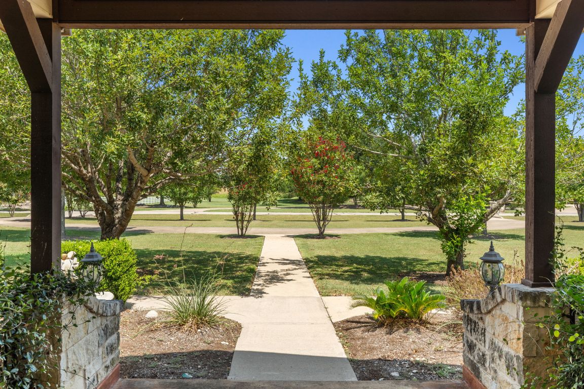 218 Courtnee's Way Georgetown, TX 78626 - Photo 31 of 36 From the front porch, the view is both welcoming and picturesque, framed by lush, well-manicured landscaping that sets a warm first impression ~