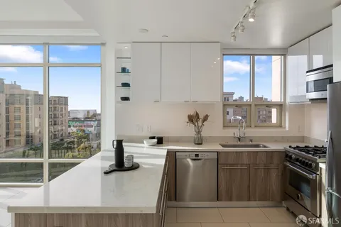 a kitchen with stainless steel appliances granite countertop a sink stove and cabinets