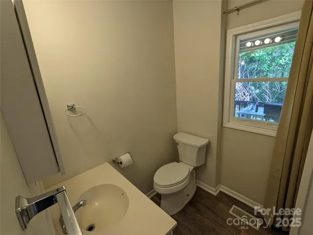 a white toilet sitting next to a sink