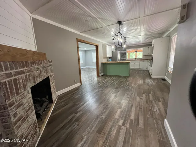 a view of a kitchen with a sink wooden floor and a kitchen