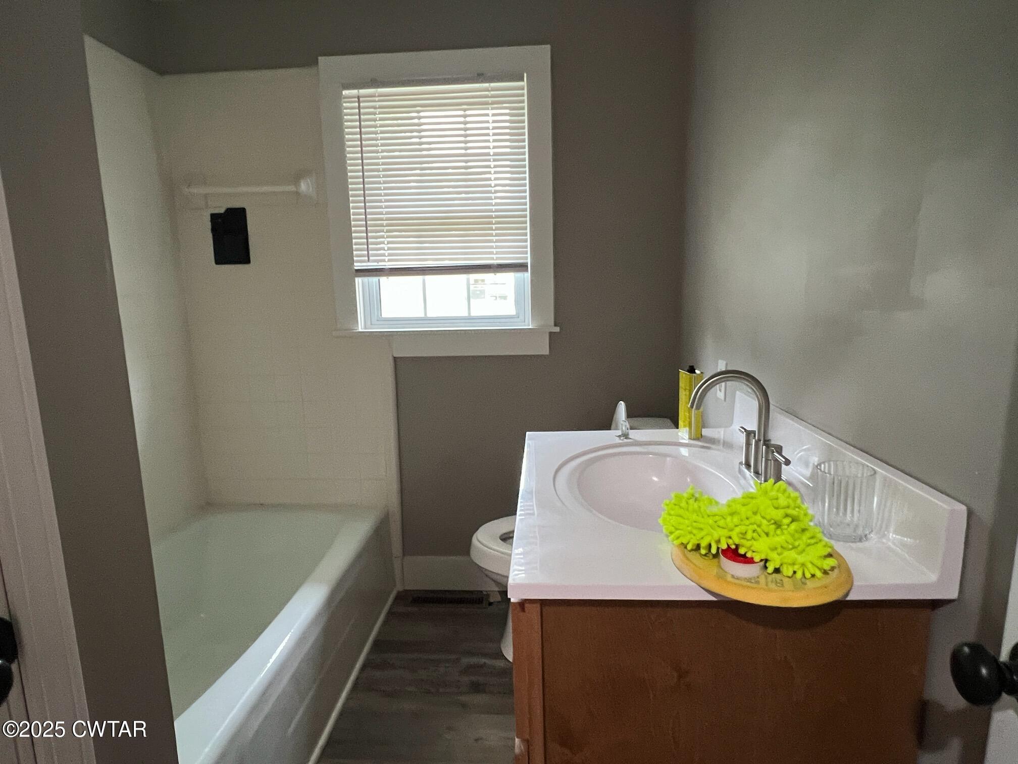 1056 Phelps Lane Milan, TN 38358 - Photo 8 of 17 a bathroom with a sink and a bathtub