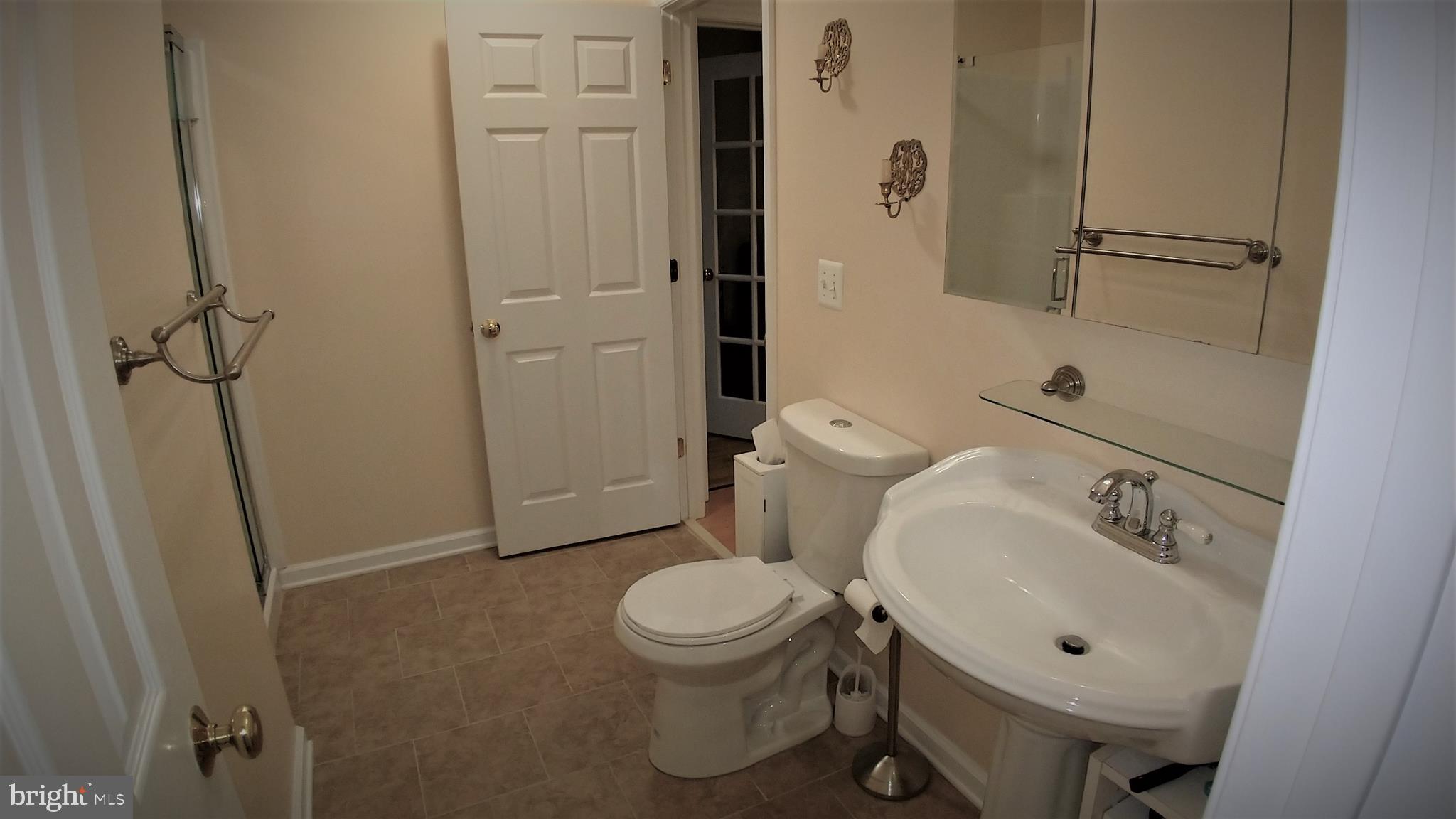 5582 Quiet Brook Road Fairfax, VA 22030 - Photo 30 of 31 Hall bath redecorated with ceramic tile and paint.