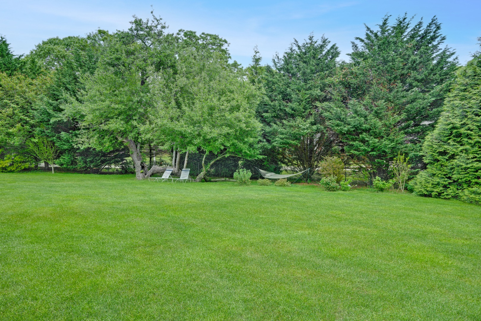 8 Fresh Pond Road Oak Bluffs, MA 02557 - Photo 32 of 36 a view of green field with trees in the background
