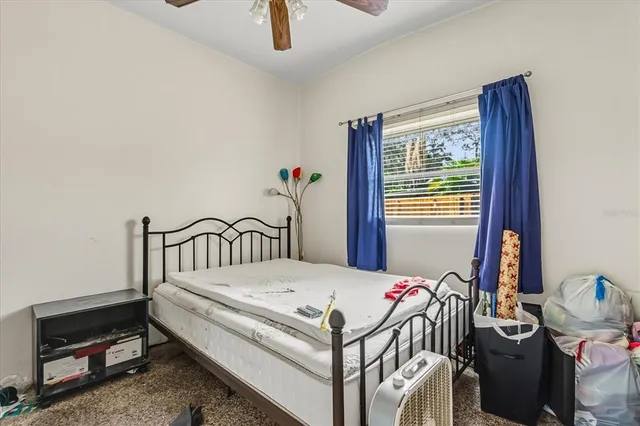 a bedroom with bed and a window