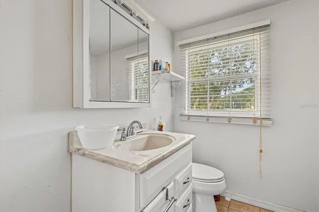 a bathroom with a tub sink and a window