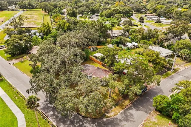 an aerial view of residential houses with outdoor space and swimming pool