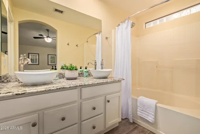 a bathroom with a granite countertop sink mirror and a