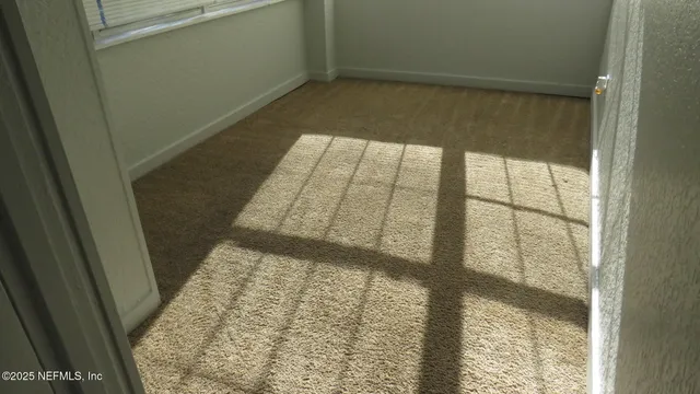 a view of an empty room and window