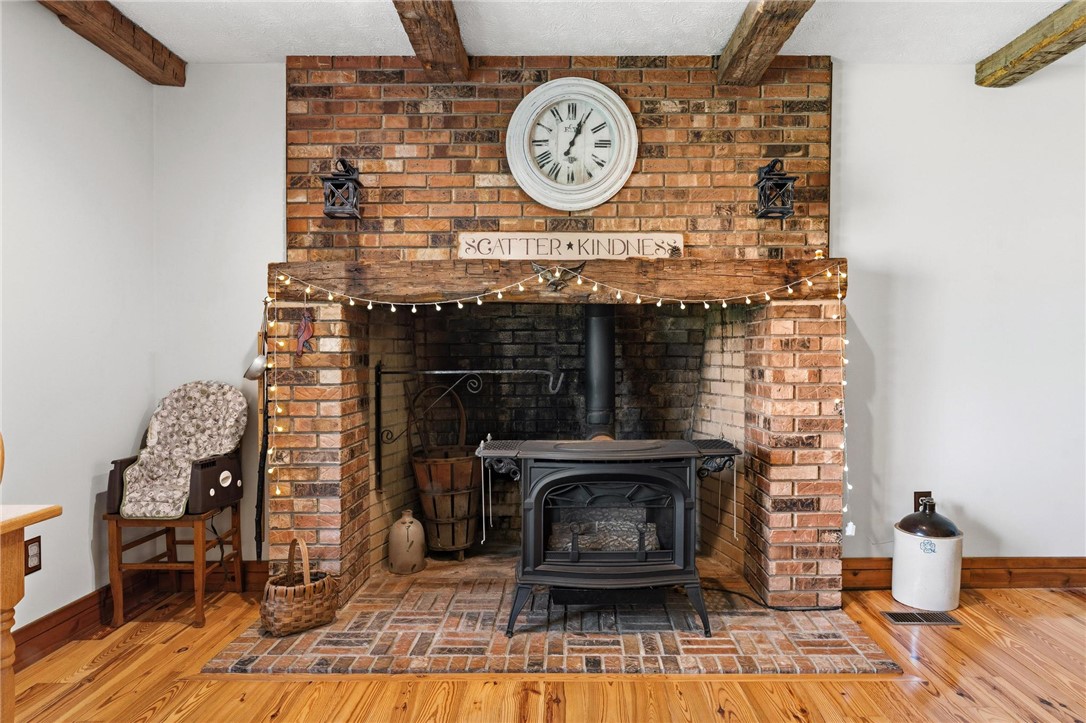 4971 Lackey Road Cedarville, OH 45314 - Photo 23 of 79 This inviting space features a charming brick fireplace with a classic wood-burning stove.