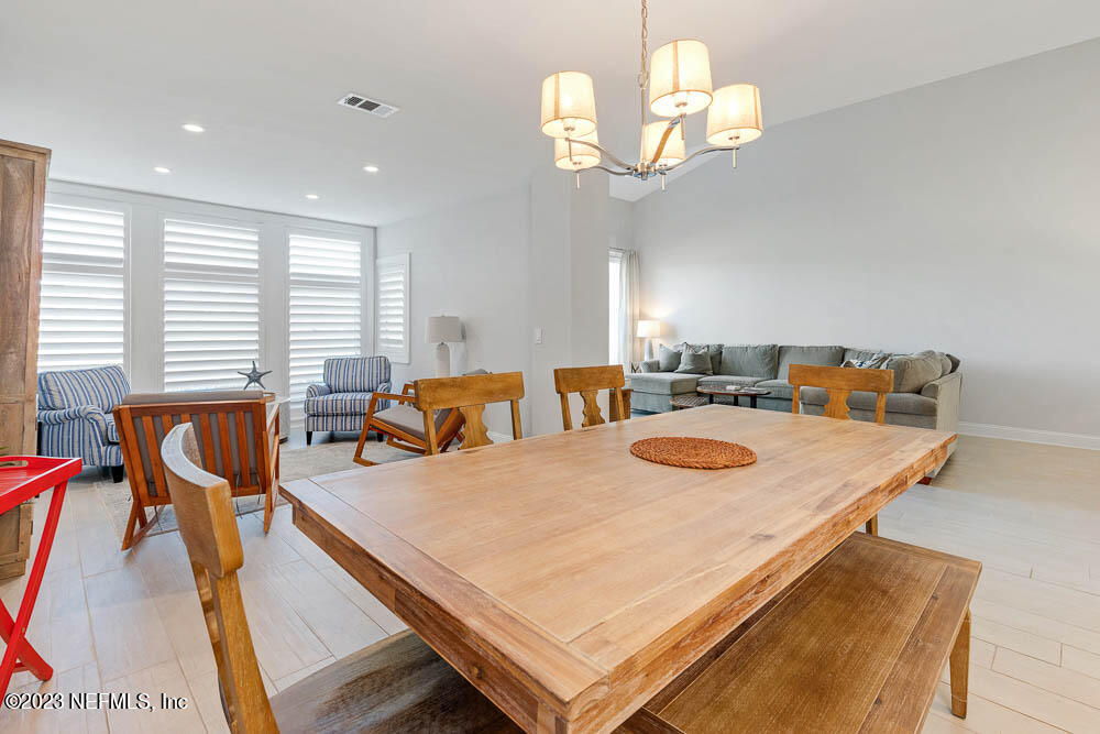 10 Cove Road Ponte Vedra Beach, FL 32082 - Photo 14 of 31 a dining room with furniture and a chandelier