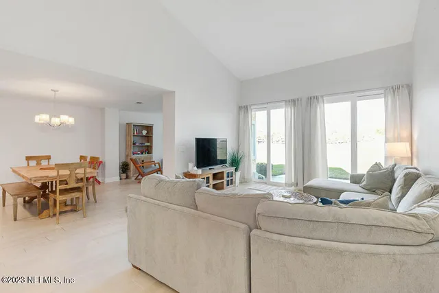 a living room with furniture and large windows