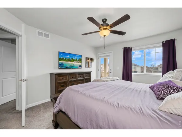 a bedroom with a bed and a large window
