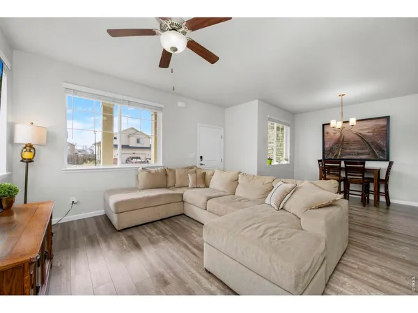 a living room with furniture and wooden floor