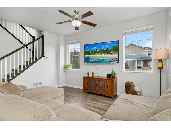 a bedroom with furniture and a flat screen tv