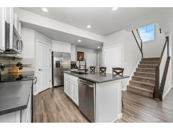 a kitchen with a sink stainless steel appliances and cabinets