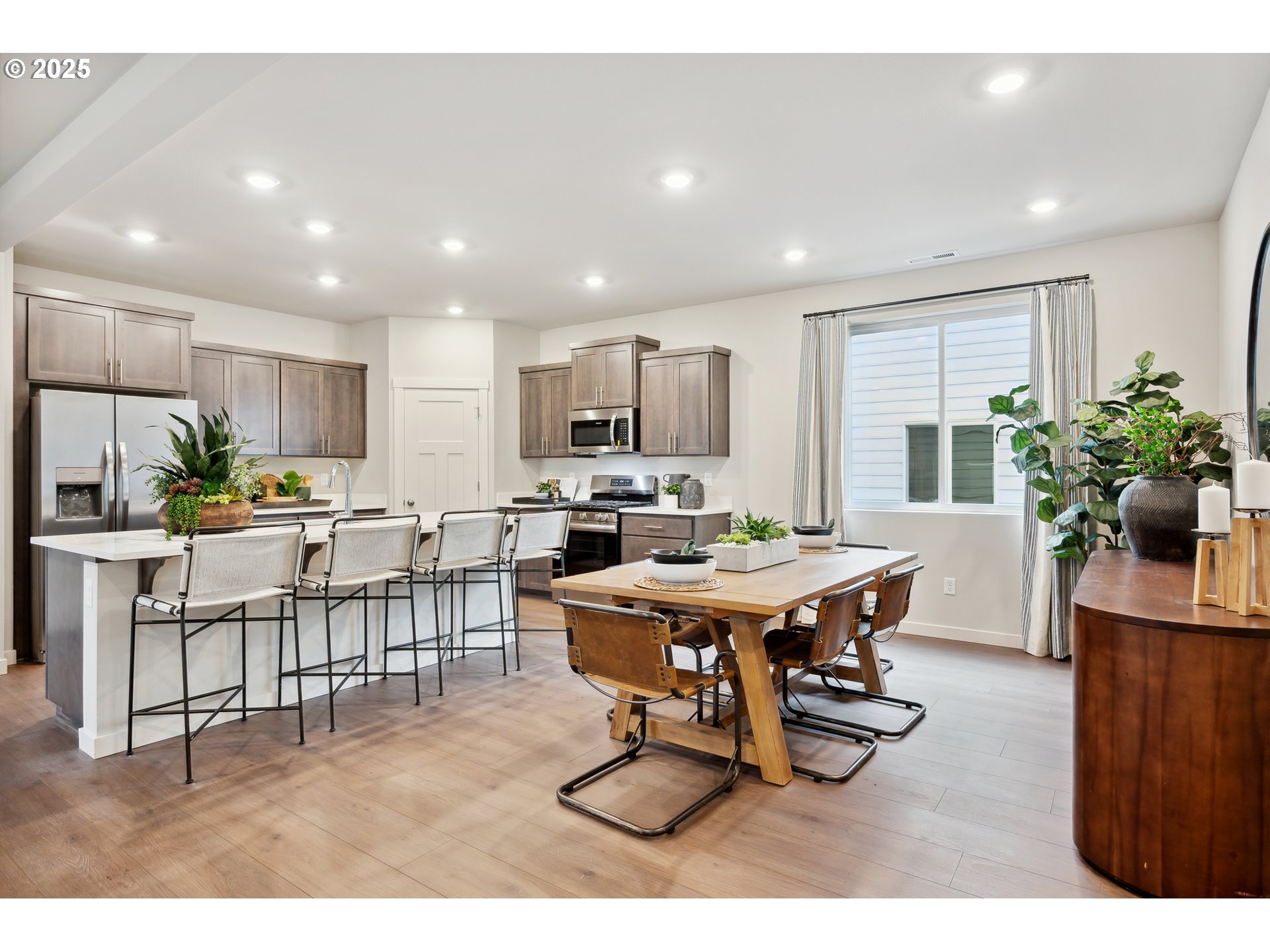 996 Legacy Lane Eugene, OR 97402 - Photo 6 of 37 a dining room with furniture a potted plant and kitchen view