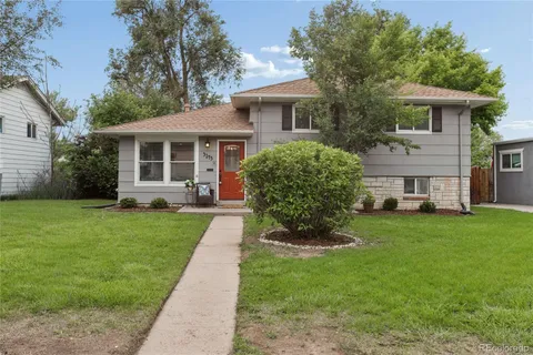 a view of a house with a yard and sitting area