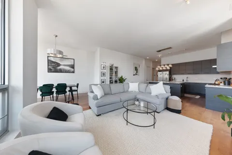 a living room with furniture or couch and a view of kitchen