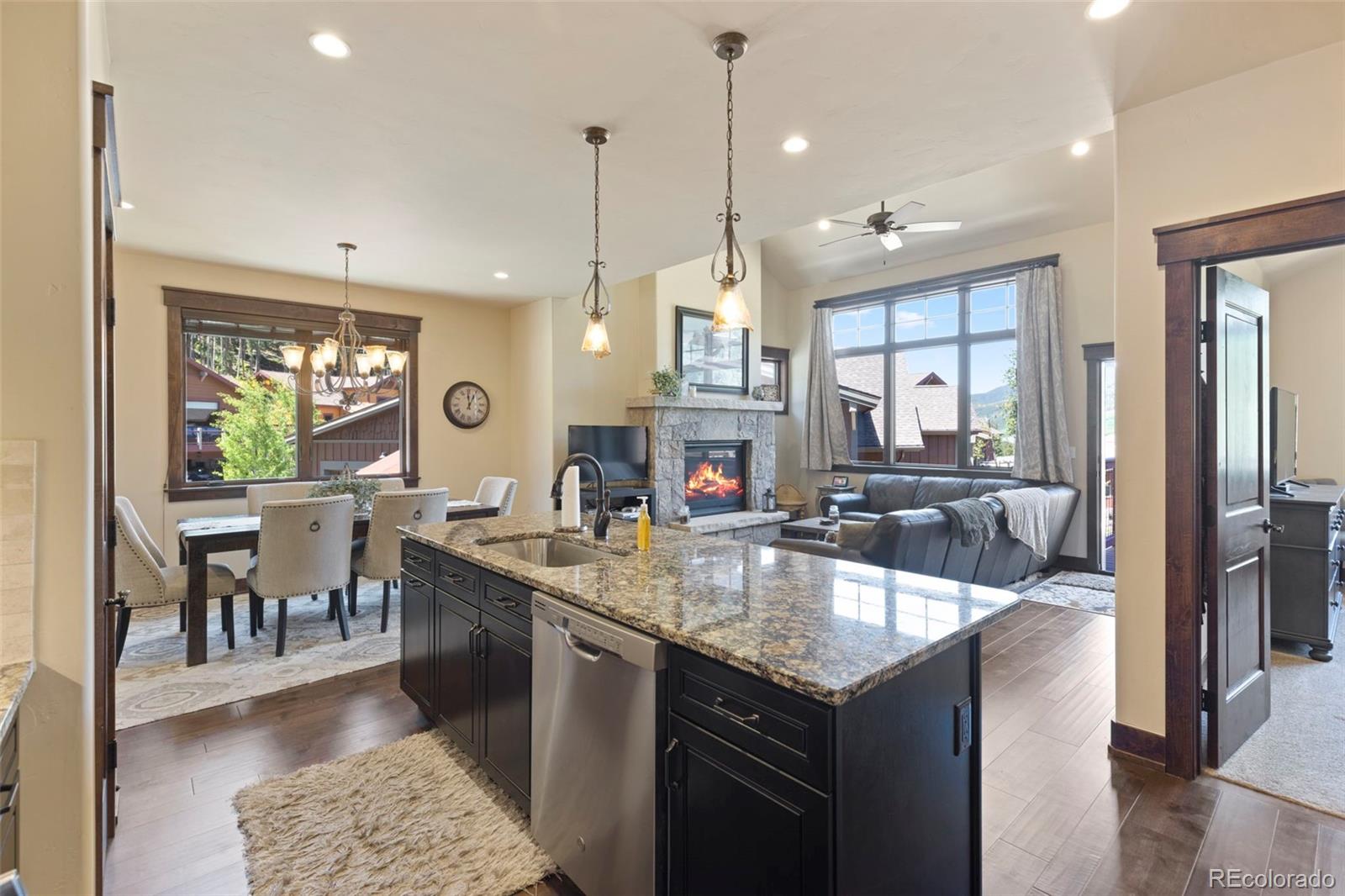 799 Independence Road Keystone, CO 80435 - Photo 13 of 44 a kitchen with a stove center island a sink and a dining table with chairs