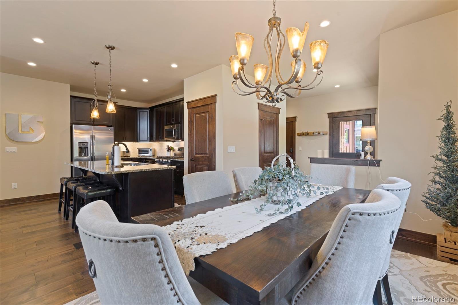 799 Independence Road Keystone, CO 80435 - Photo 17 of 44 a kitchen with kitchen island stainless steel appliances sink stove dining table and chairs