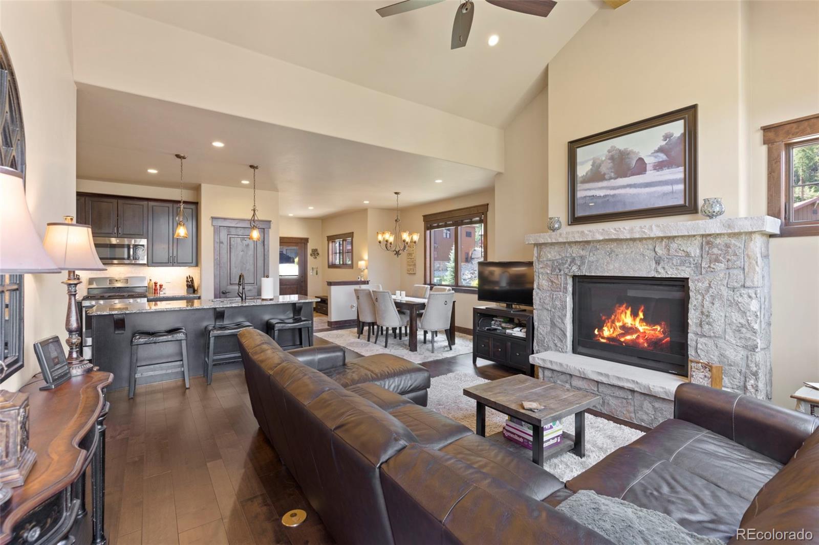 799 Independence Road Keystone, CO 80435 - Photo 3 of 44 a living room with furniture a fireplace and kitchen view