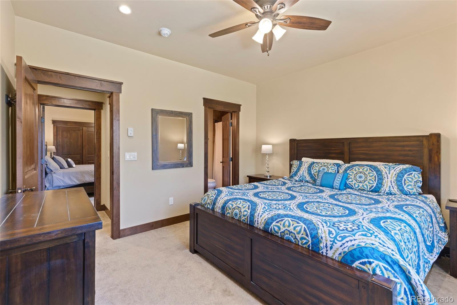 799 Independence Road Keystone, CO 80435 - Photo 39 of 44 a bedroom with a bed and a chandelier