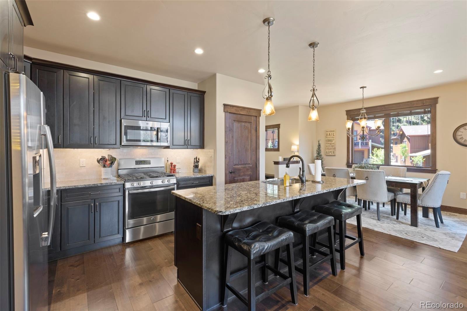 799 Independence Road Keystone, CO 80435 - Photo 10 of 44 a large kitchen with kitchen island a dining table and chairs