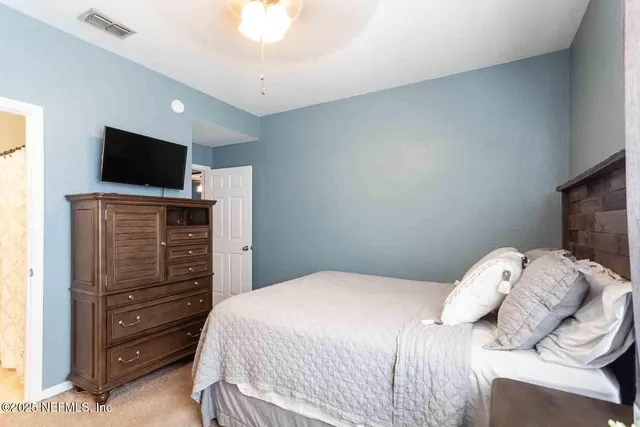 a bedroom with a bed and flat screen tv