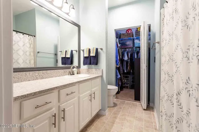 a bathroom with a double vanity sink a mirror and a shower
