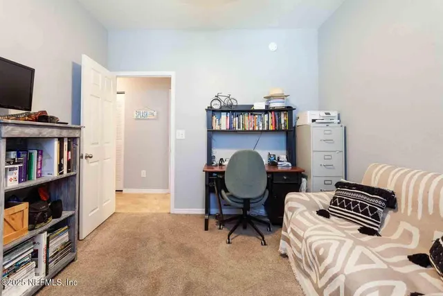 a bedroom with furniture and a book shelf