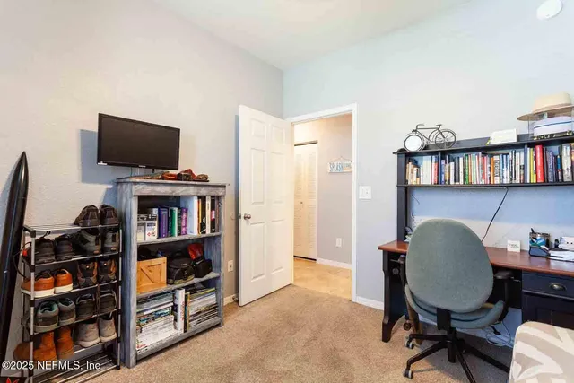 a view of a livingroom with furniture and a bookshelf