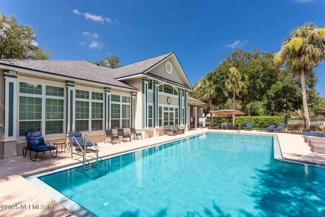 a swimming pool with outdoor seating and yard
