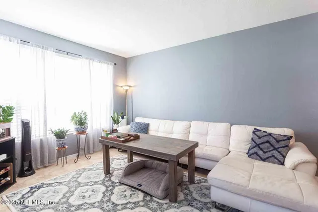 a living room with furniture and a window