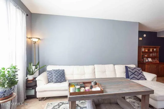 a living room with furniture and flowers