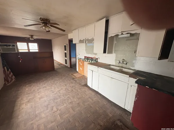 a kitchen with sink cabinets and window